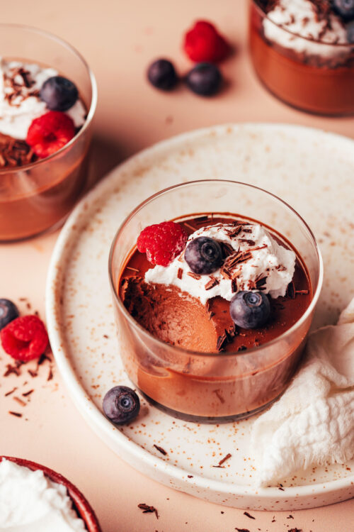 Three small glass jars filled with out vegan chocolate pot de creme recipe