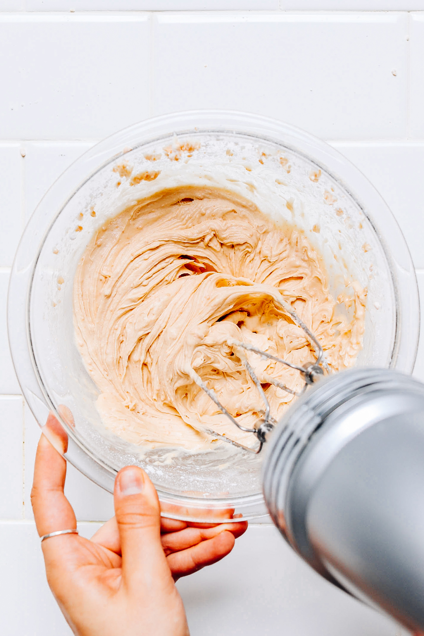Using a hand mixer to whip frosting