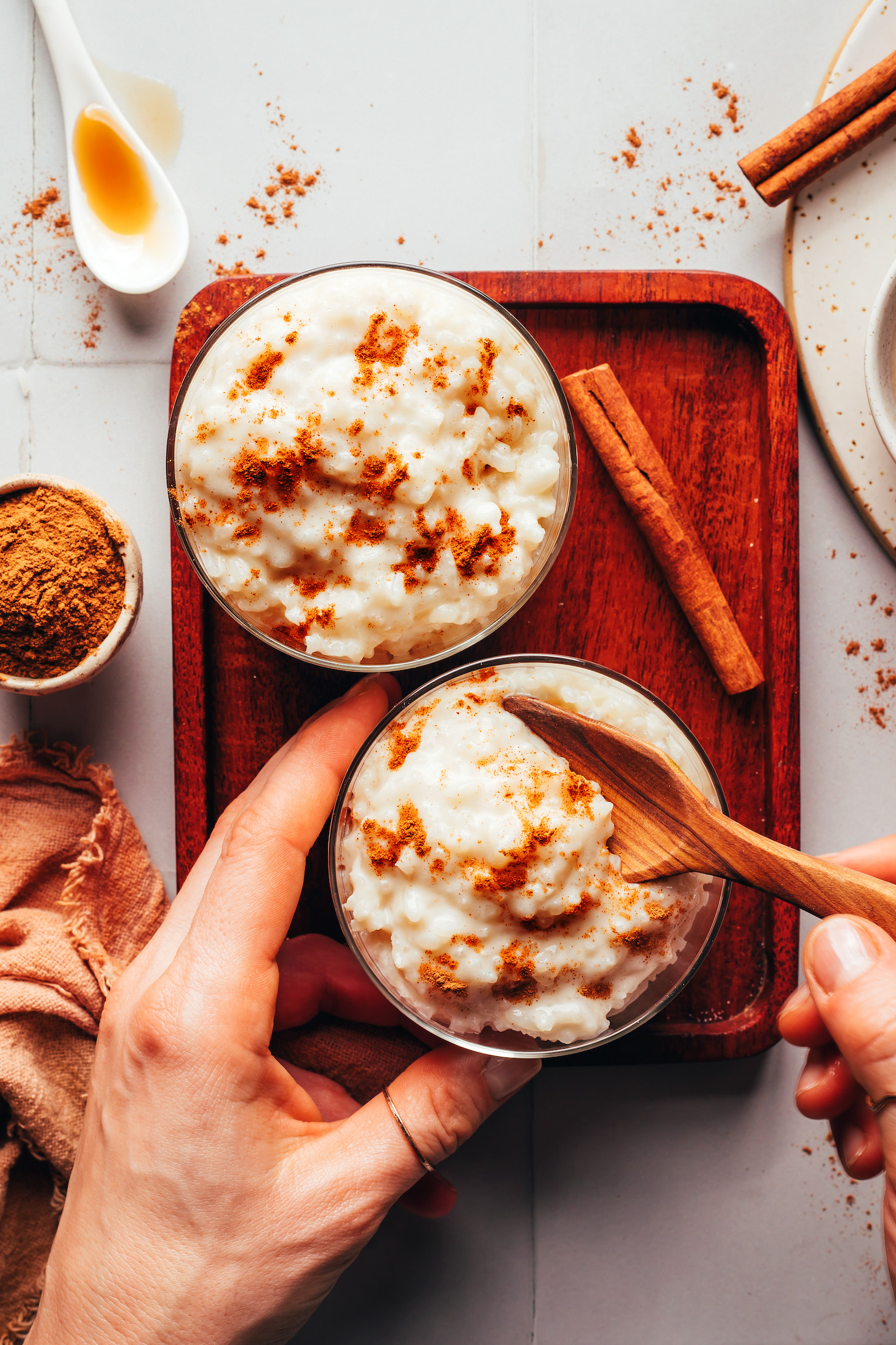 Spoon scooping out rice pudding from a glass