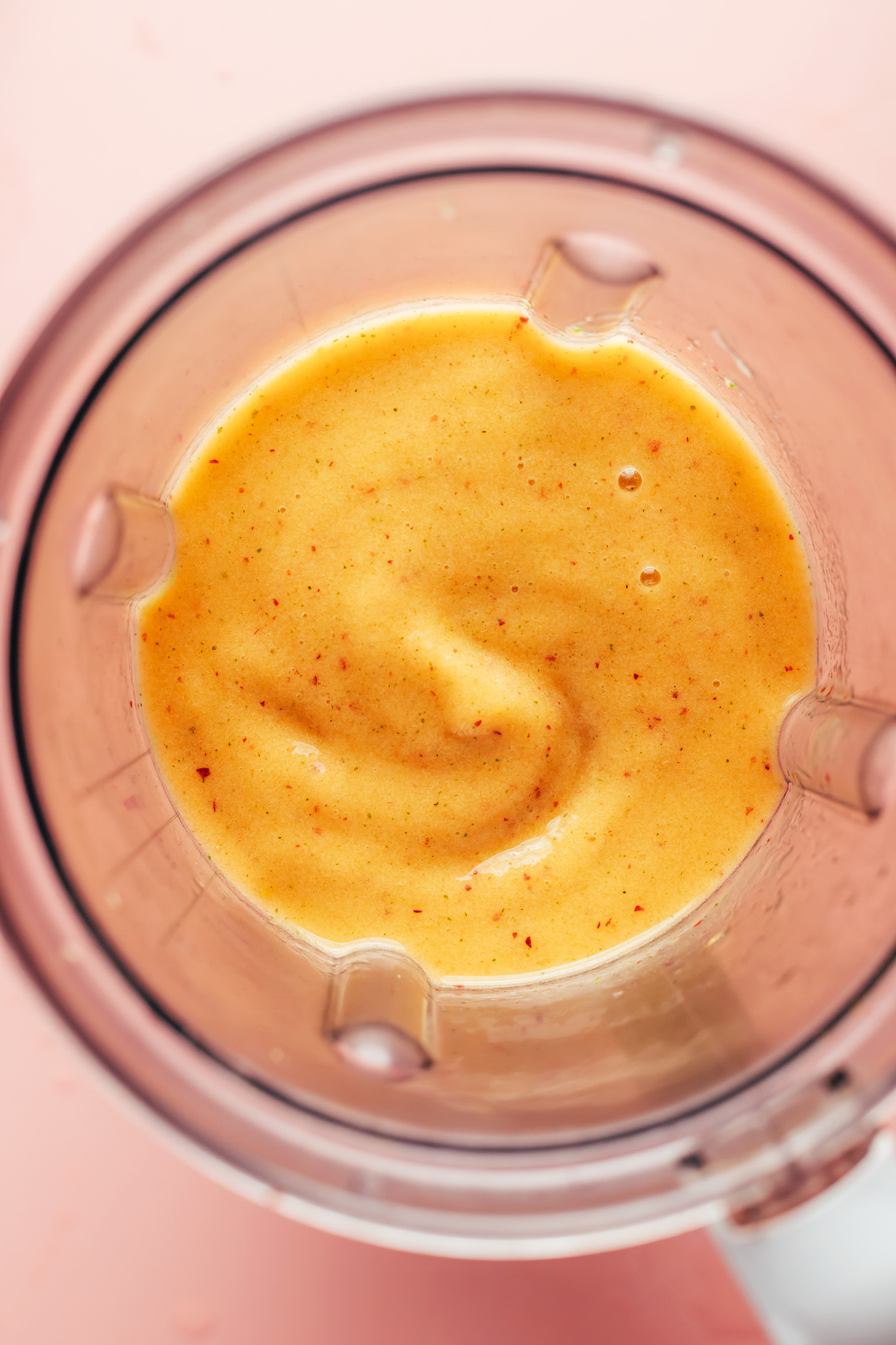 Blended homemade frozen peach daiquiri in a blender