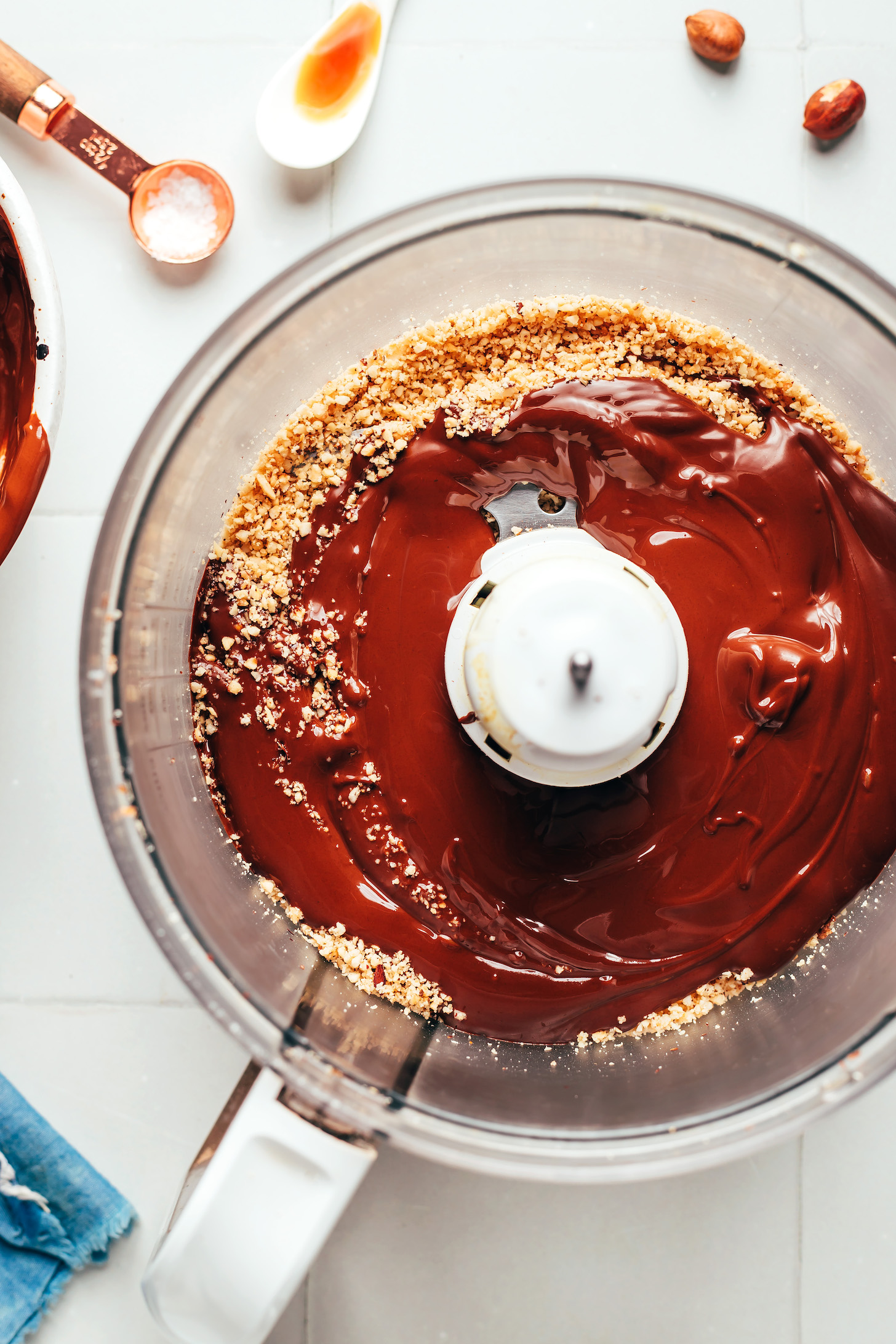 Blender with finely chopped hazelnuts and melted chocolate