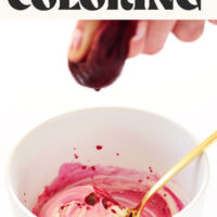 Sprinkling beet juice into a bowl of frosting to make pink frosting with DIY natural food coloring