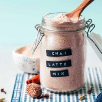 Small wooden spoon resting in a jar of Chai Latte Mix