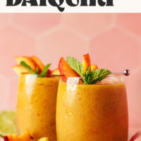 Two glasses of our frozen peach daiquiri recipe with text above that says 2 different ways to indicate boozy and non-alcoholic options