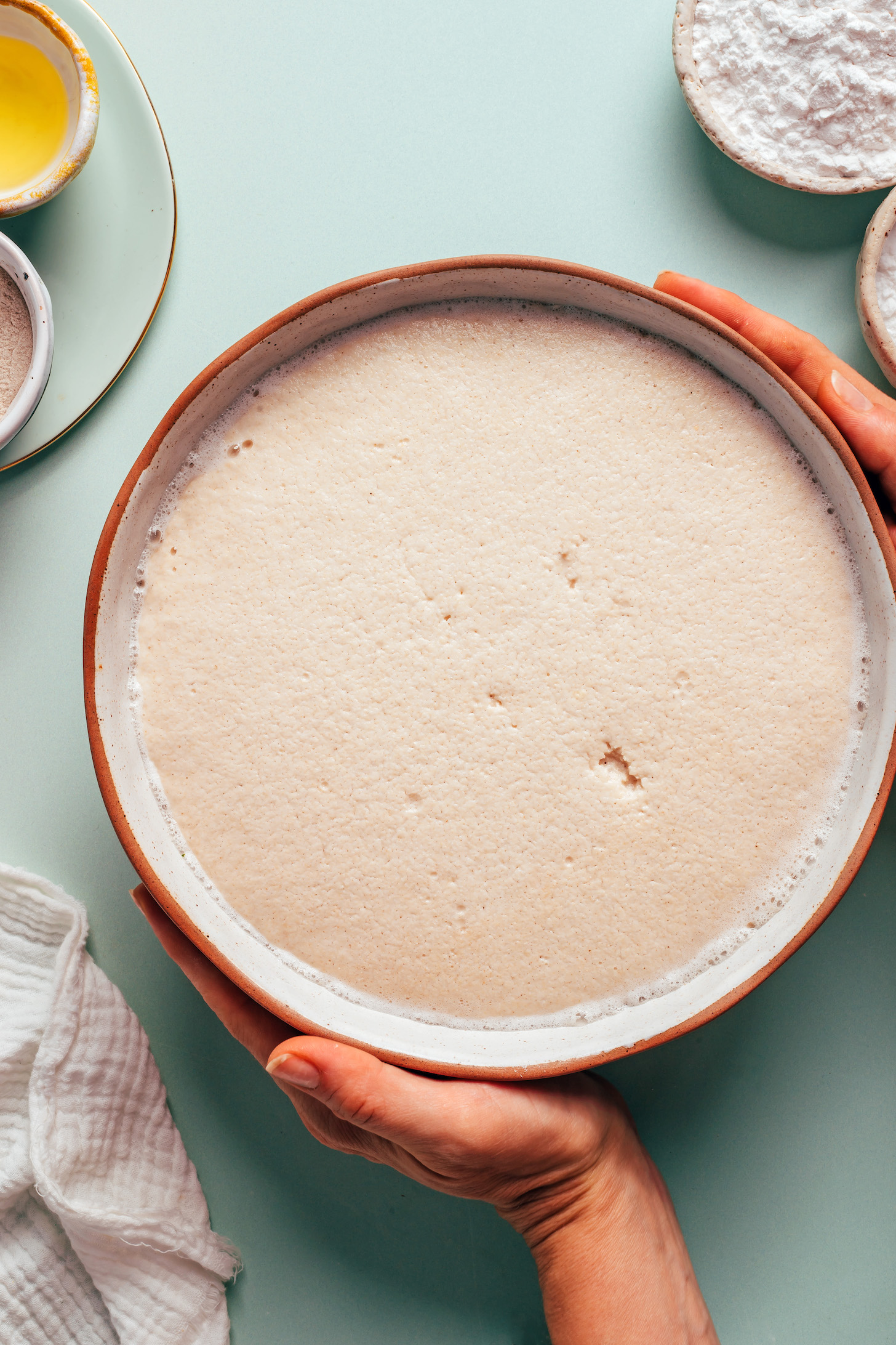 Bowl of proofed yeast with psyllium husk powder and brown rice flour