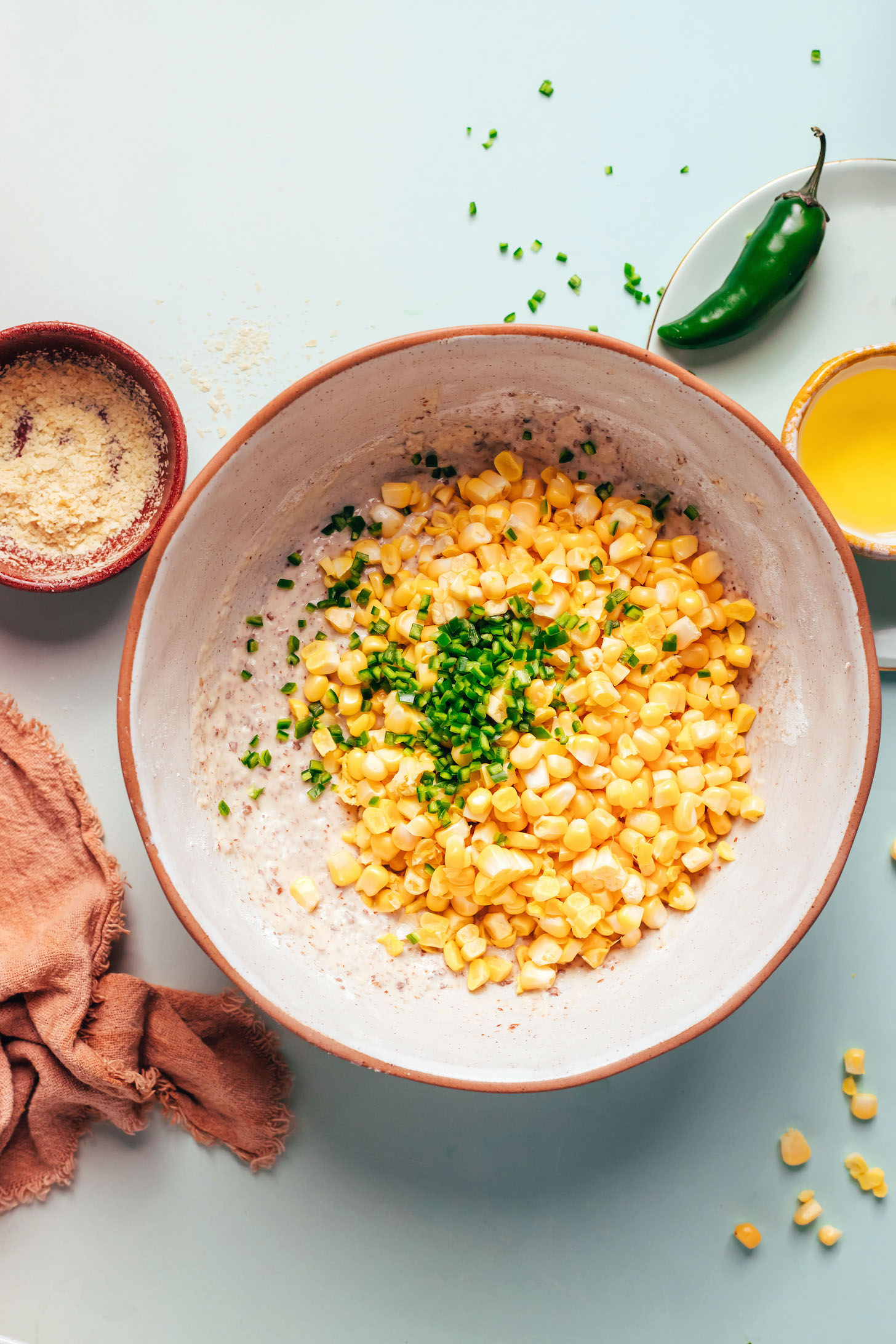Bowl with batter, corn kernels, and finely chopped jalapeño